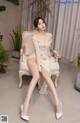 a woman sitting on top of a white chair