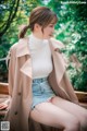 a woman sitting on top of a wooden bench