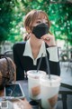 a woman sitting at a table with a cup of coffee