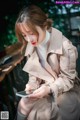 A woman sitting on a bench looking at her phone.