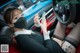 A woman wearing a face mask while sitting in a car.